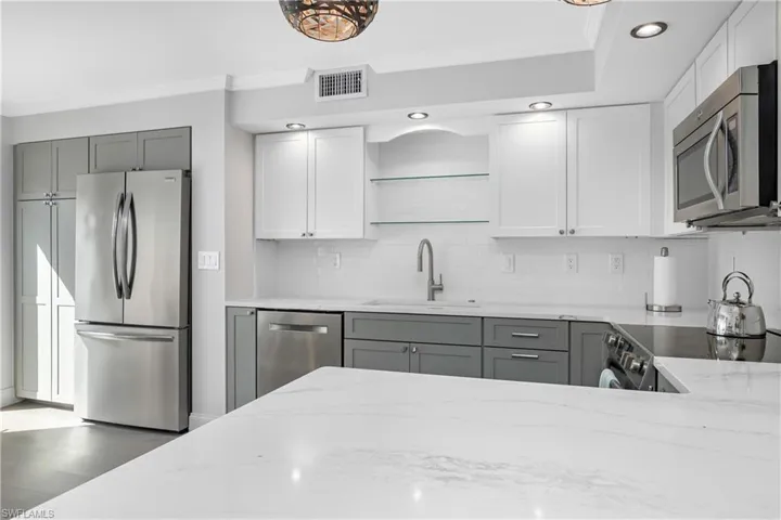Kitchen with stainless steel appliances and quartz countertops