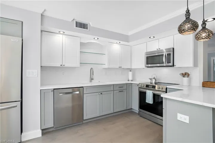 Kitchen with stainless steel appliances and quartz countertops