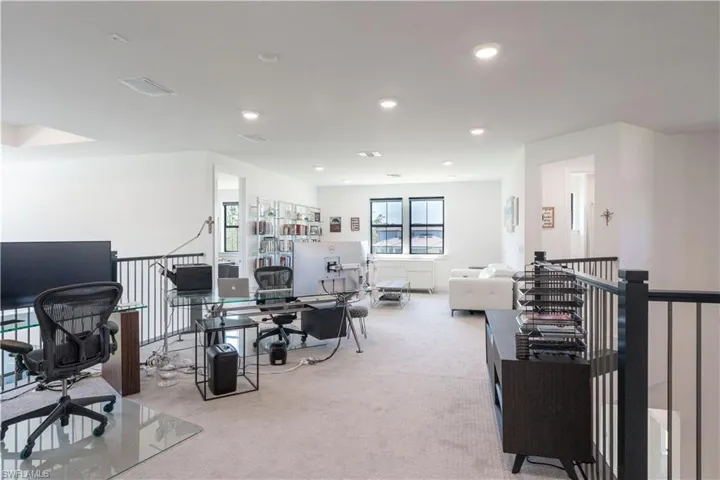 Carpeted office space with recessed lighting