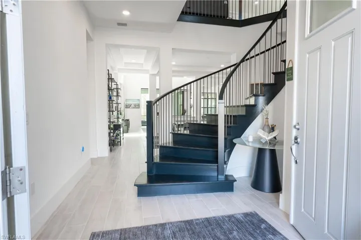 Stairs with visible vents, baseboards, and recessed lighting