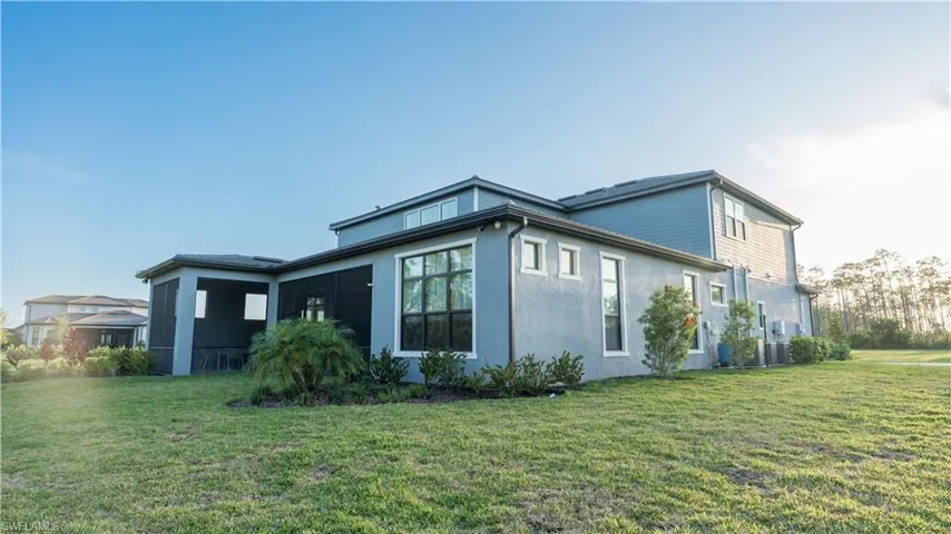 View of side of property featuring a yard and stucco siding