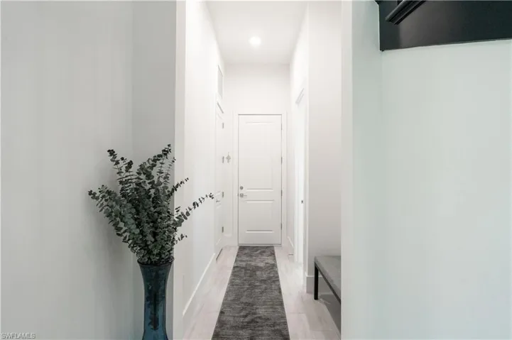 Hall with baseboards and recessed lighting