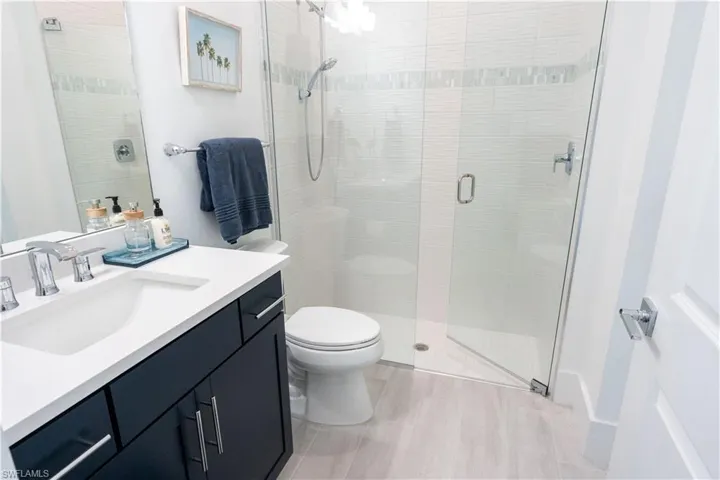 Bathroom with vanity, toilet, and a shower stall
