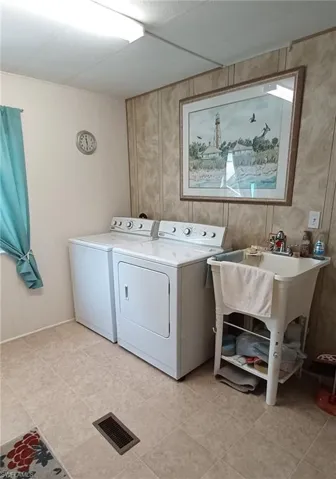 Laundry room featuring independent washer and dryer and light tile patterned floors