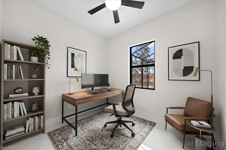 Office area featuring baseboards and a ceiling fan