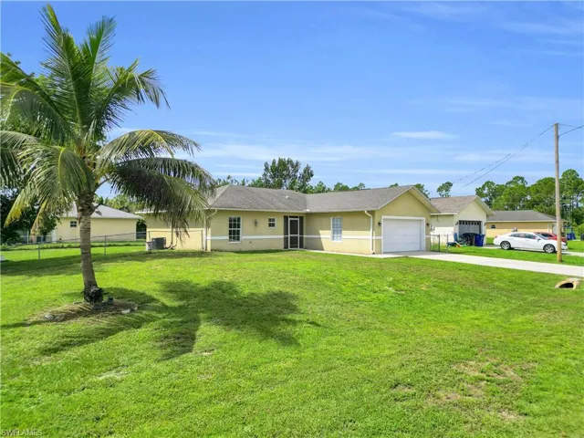 Single story home featuring driveway, stucco siding, and a garage
