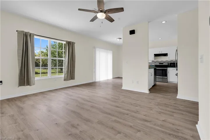 Unfurnished living room with light wood-style floors, a ceiling fan, and recessed lighting