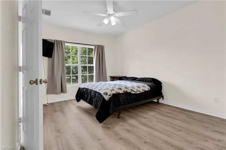 Bedroom featuring wood finished floors and ceiling fan