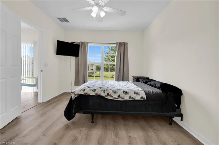 Bedroom featuring wood finished floors and ceiling fan