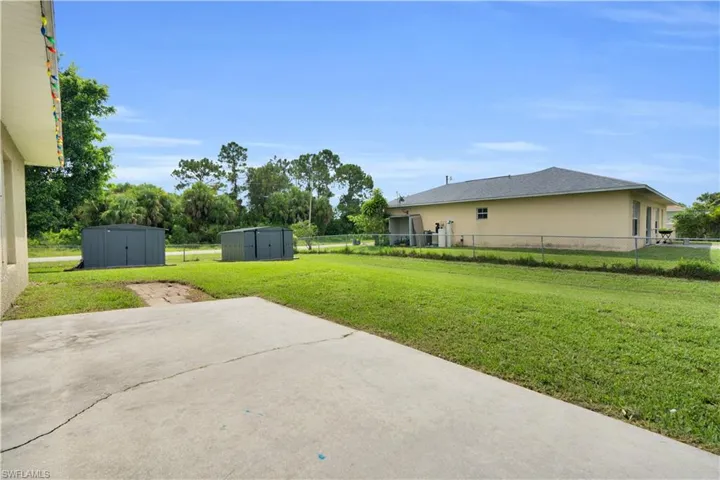 Fenced backyard featuring a shed and a patio