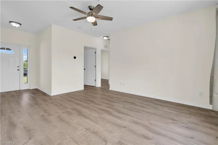 Unfurnished living room featuring light wood-style flooring and a ceiling fan