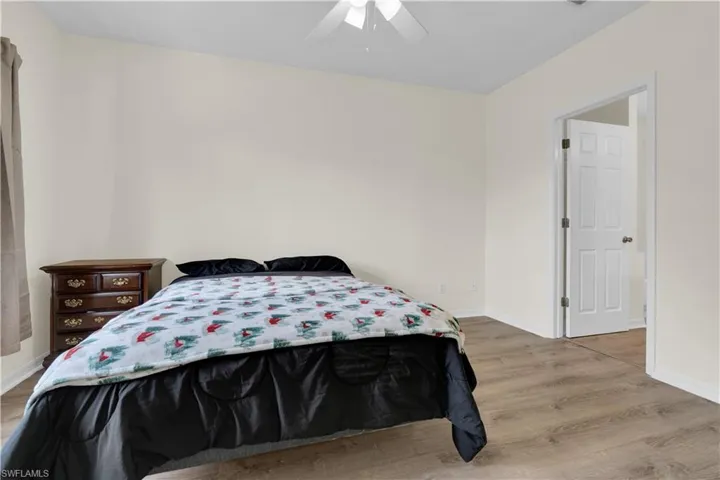 Bedroom with light wood-style flooring and a ceiling fan