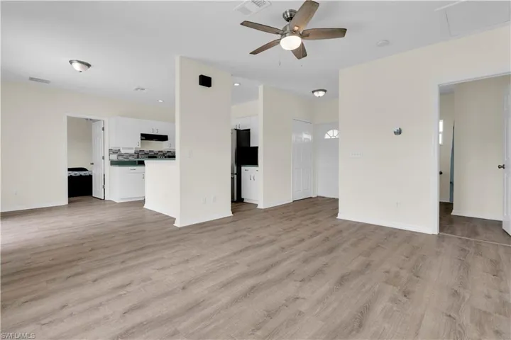 Unfurnished living room with light wood-style floors and ceiling fan