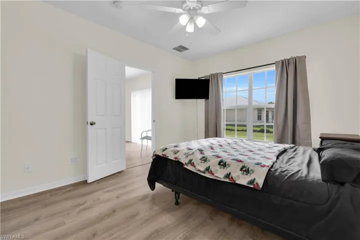 Bedroom with wood finished floors and a ceiling fan