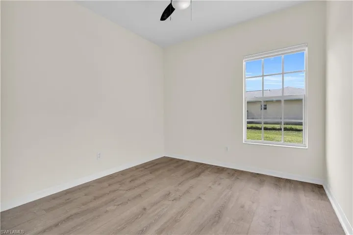 Unfurnished room featuring light wood finished floors and ceiling fan
