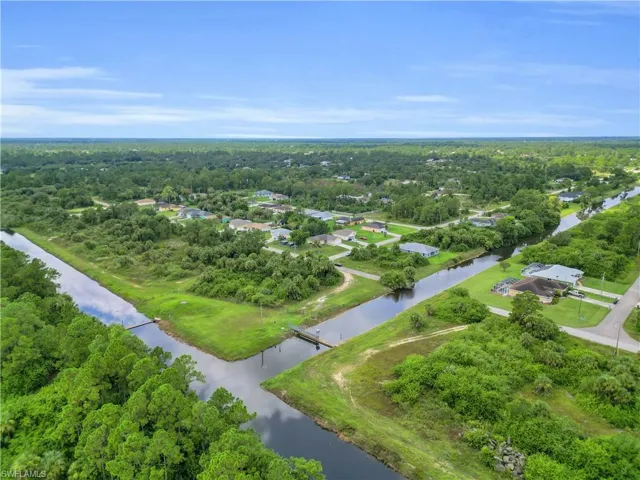 Aerial view of property's location featuring a nearby body of water