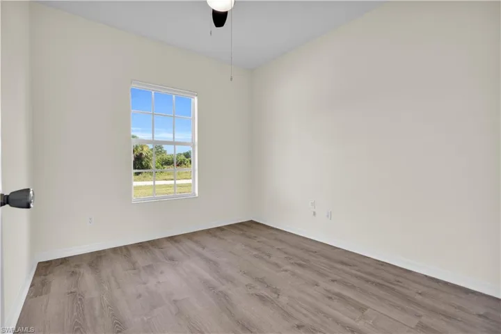 Unfurnished room with wood finished floors and ceiling fan