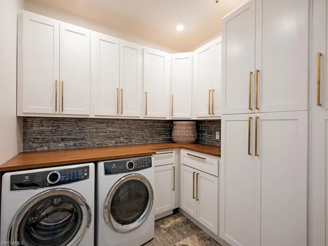 Spacious laundry with extra storage space.