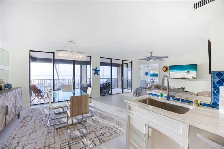 Dining area featuring floor to ceiling windows and a ceiling fan