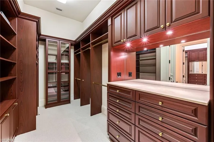 Spacious closet with light colored carpet