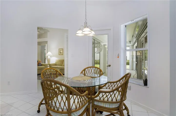 Tiled living room featuring high vaulted ceiling and ceiling fan