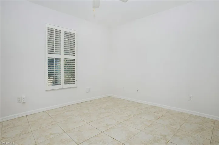 Bedroom 2 Tiled empty room with ceiling fan