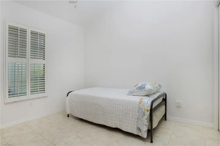 Bedroom 3 with light tile floors