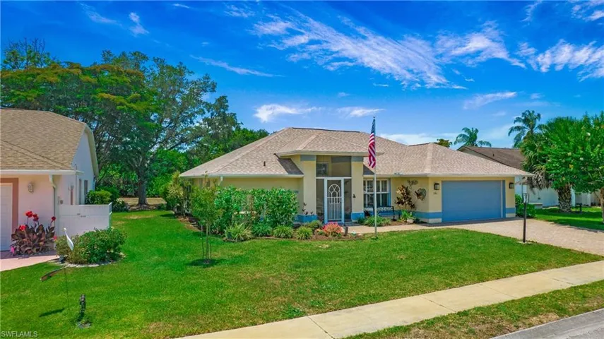 Single story home featuring a garage and a front yard