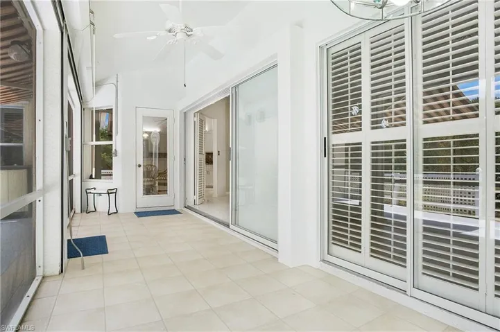 Unfurnished sunroom with ceiling fan
