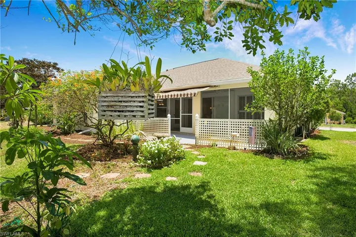Rear view of house featuring a lawn