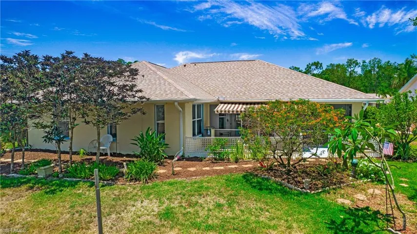 Rear view of house featuring a lawn