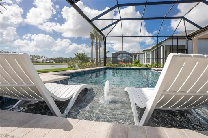 Swimming pool featuring a patio, glass enclosure, and a sunroom