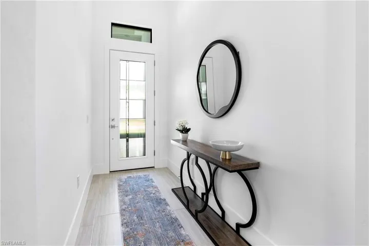 Foyer entrance with baseboards