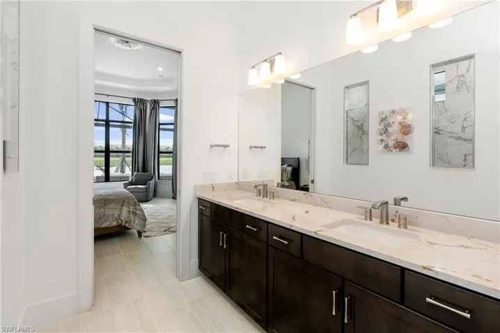 Ensuite bathroom with double vanity and baseboards