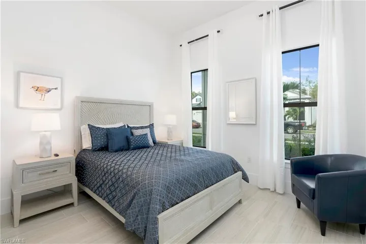 Bedroom with baseboards and wood finish floors