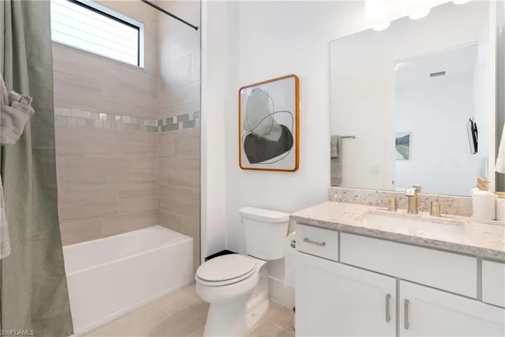 Bathroom with vanity and shower / tub combo with curtain