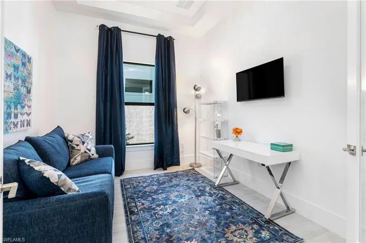 Living room featuring light wood-style floors and baseboards