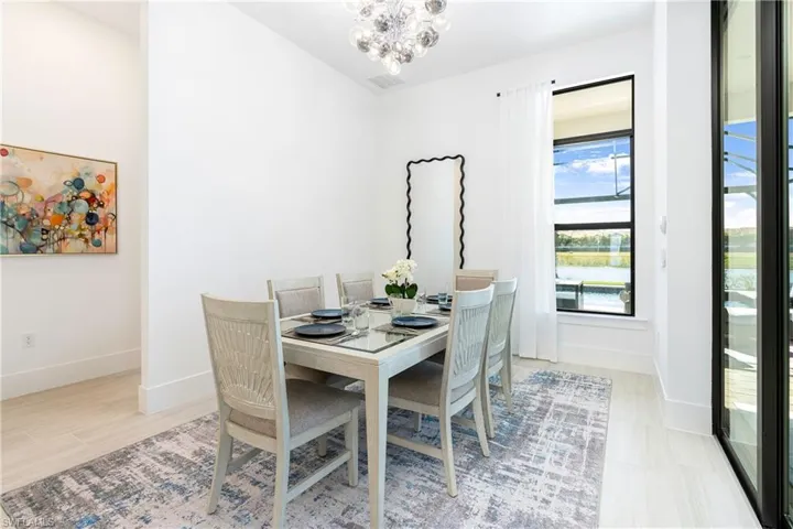 Dining area with a chandelier and baseboards