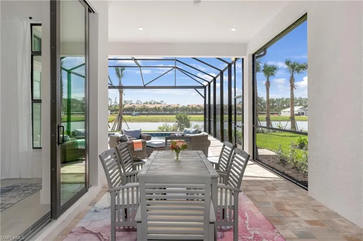 Sunroom featuring a patio, outdoor lounge area, a water view, and outdoor dining space
