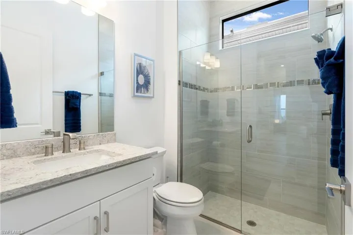 Full bath featuring vanity and a stall shower