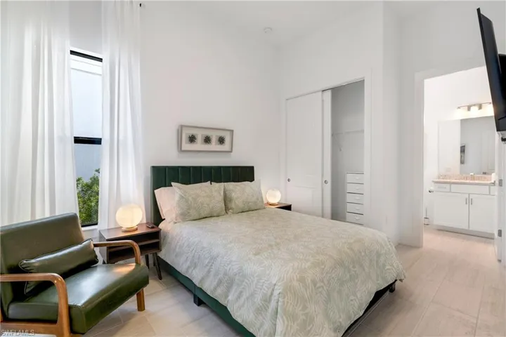 Bedroom with a closet and ensuite bath