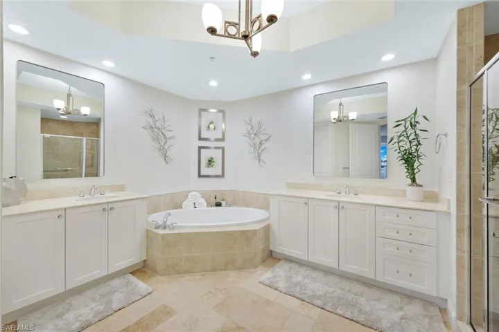 The primary en suite bathroom is serene and peaceful with large soaking tub and separate walk in shower.