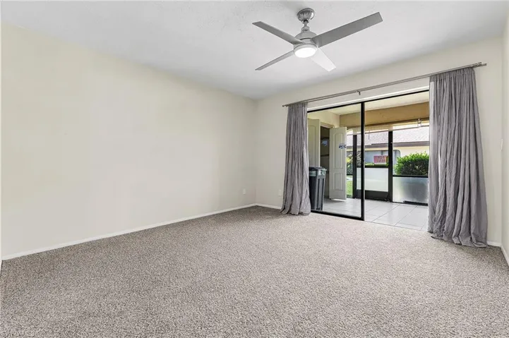 Spacious Master Bedroom w/ new paint, carpet, light fixture, drapes, fan/light.