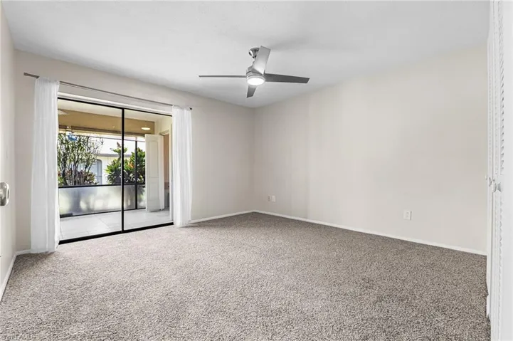 Spacious 2nd bedroom w/ new paint, carpet, drapes, and fan/light.