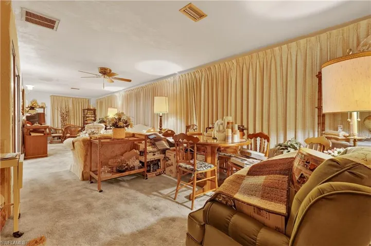 Carpeted flooring throughout, recessed ceiling lighting, and a ceiling fan with light fixture