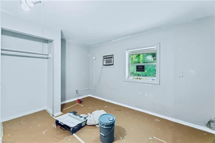 Unfurnished bedroom featuring a wall mounted AC