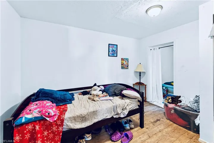 Bedroom with hardwood / wood-style flooring