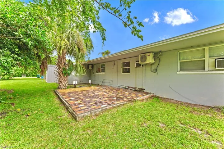 View of yard featuring a patio area and a wall mounted air conditioner
