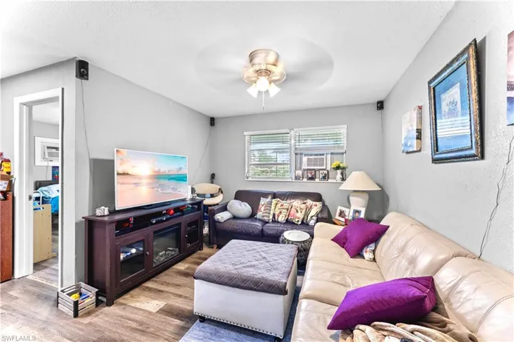 Living room with ceiling fan and wood-type flooring