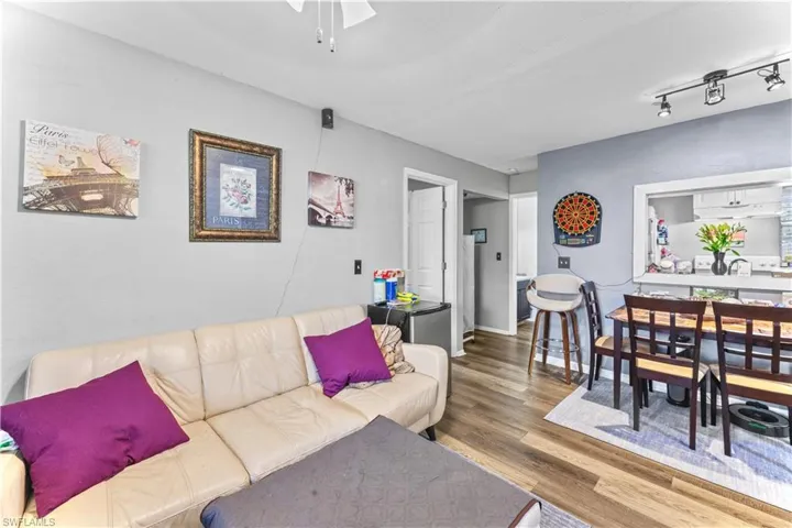 Living room featuring hardwood / wood-style flooring and rail lighting